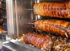 Rotisserie Whole Porchetta. Flame Show Cooking Catering or Drop Off Catering