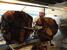 Load image into Gallery viewer, Rotisserie Whole Steamship of Beef. Flame Show Cooking Catering or Drop Off Catering
